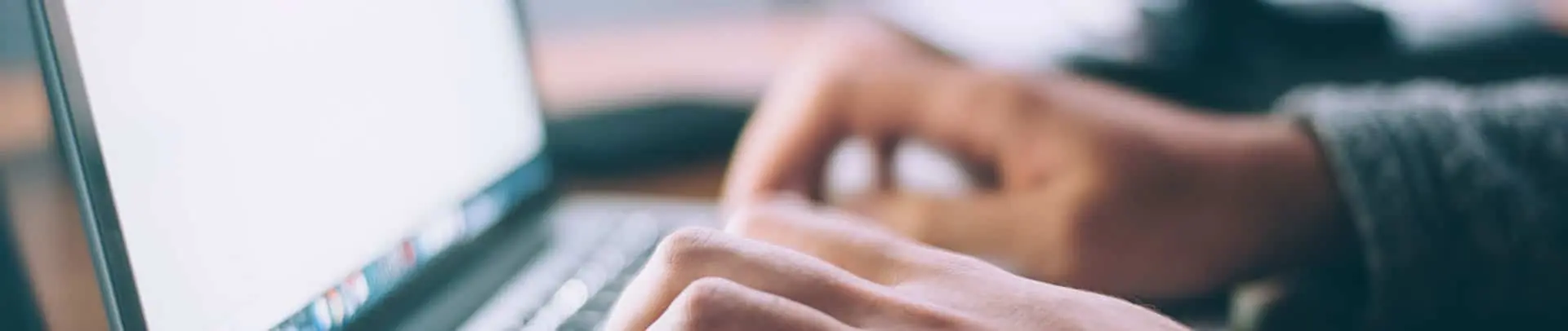 26WorkingOnLaptop_1920X406