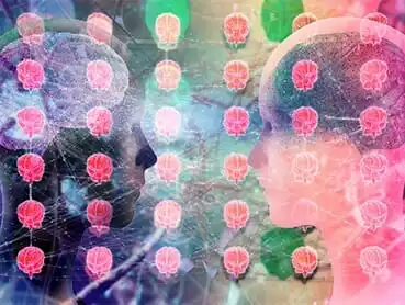 Two human heads in profile facing each other with overlapping brain images superimposed. Multiple small red brain icons are displayed between them in a grid-like pattern, against a colorful, abstract background.