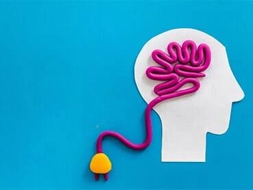 An illustration of a human head silhouette with a brain depicted as a pink cord. The cord extends out from the head and ends with a yellow and pink plug, set against a blue background.