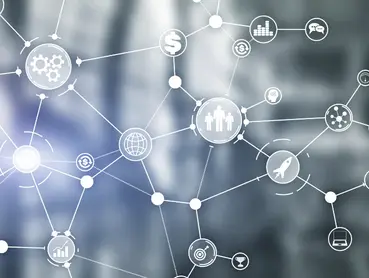 A network of interconnected icons representing various concepts, including finance, technology, communication, and human resources, over a blurred background. Lines and circles connect these symbols, illustrating a complex web of relations.